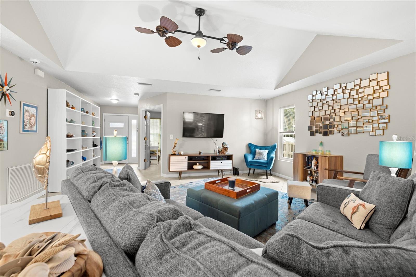 Living room with high ceilings and beautiful fans