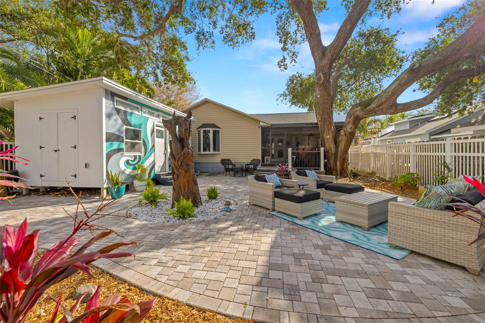 Your own backyard courtyard oasis. The custom carved oak tree art just adds to the ambiance