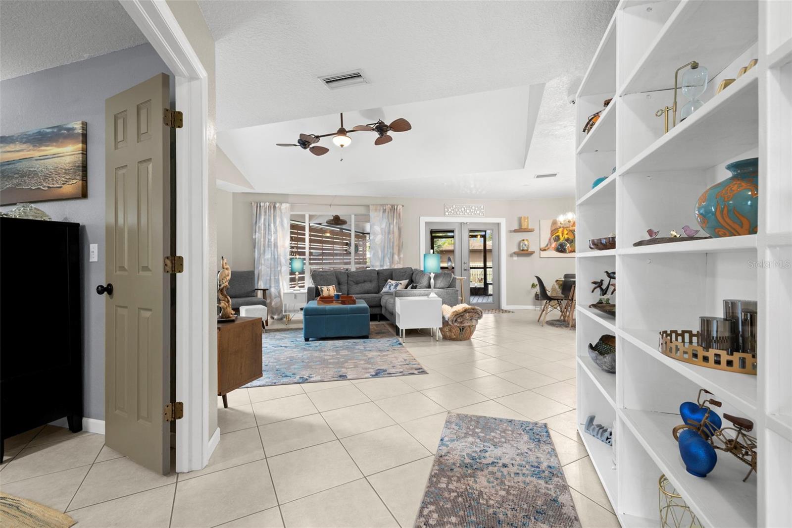 Living room with high ceilings and beautiful fans