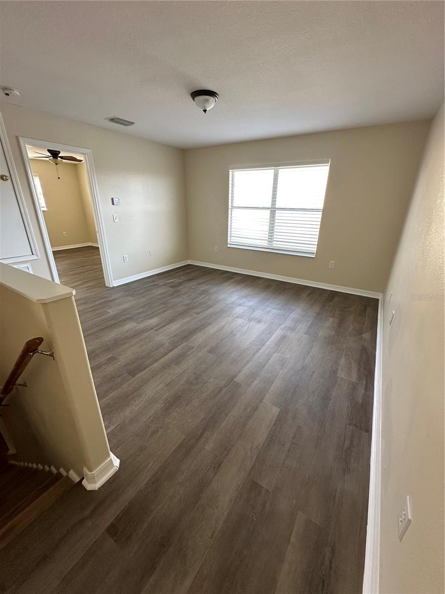 Top of Stairs View of Spacious Loft with Brand New LVP Flooring