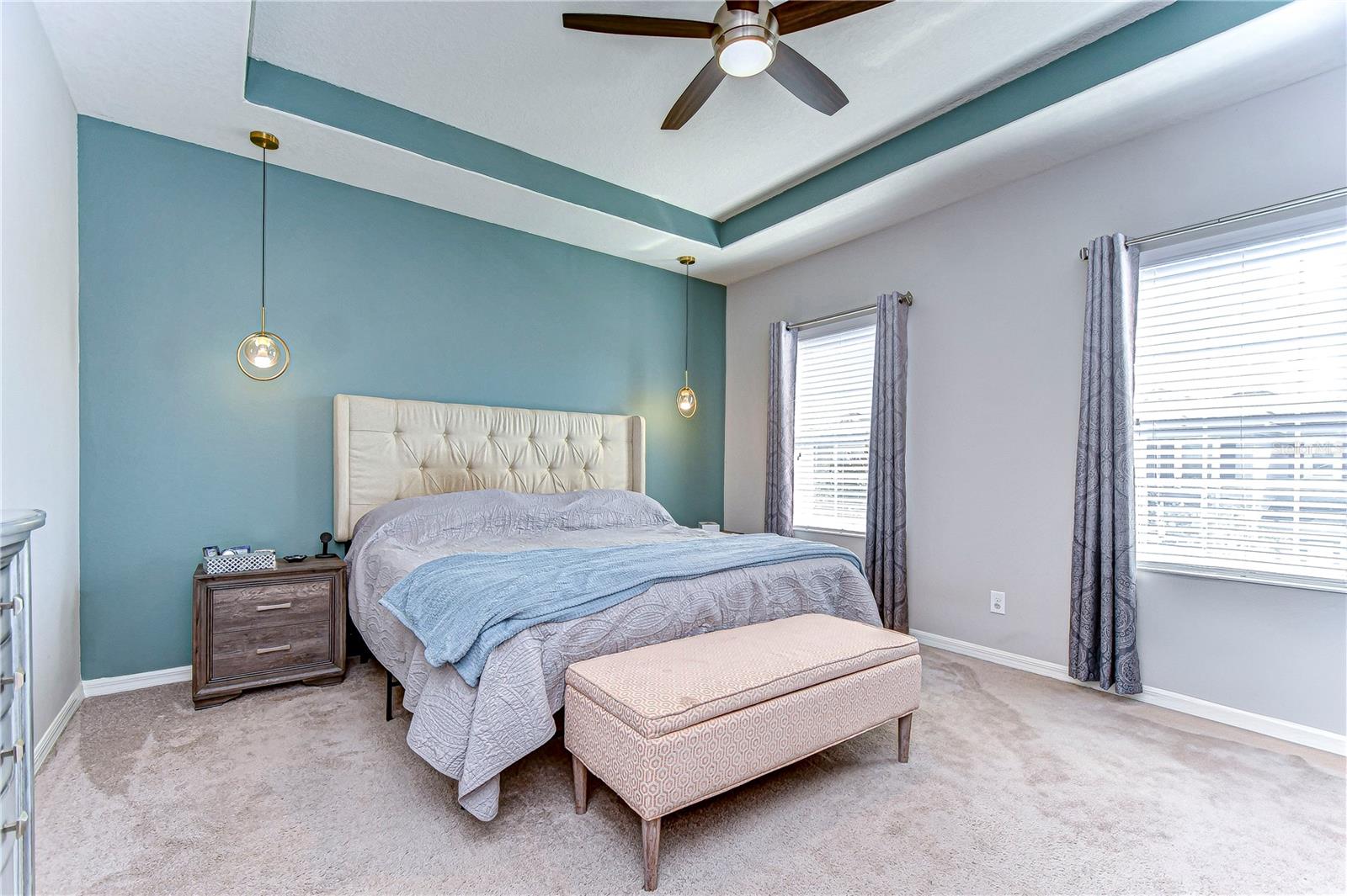 Serene primary bedroom with modern elegance.