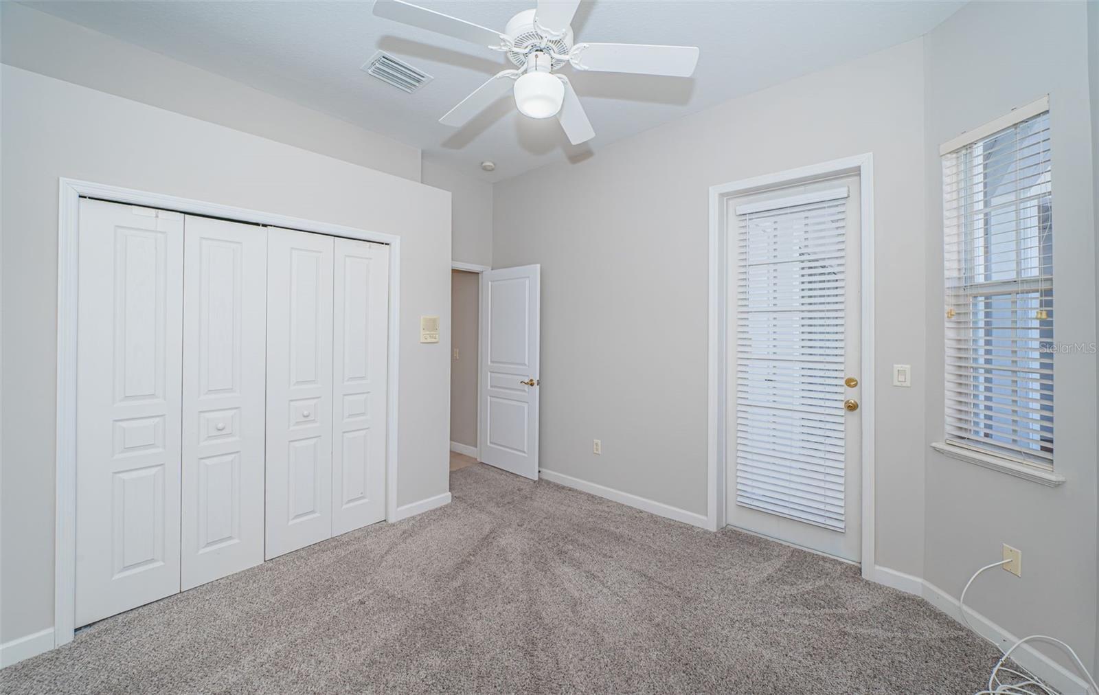 Second bedroom with entrance to pool deck.