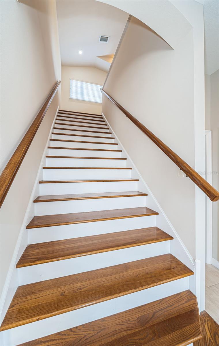 Wide staircase leading to upper bedrooms.