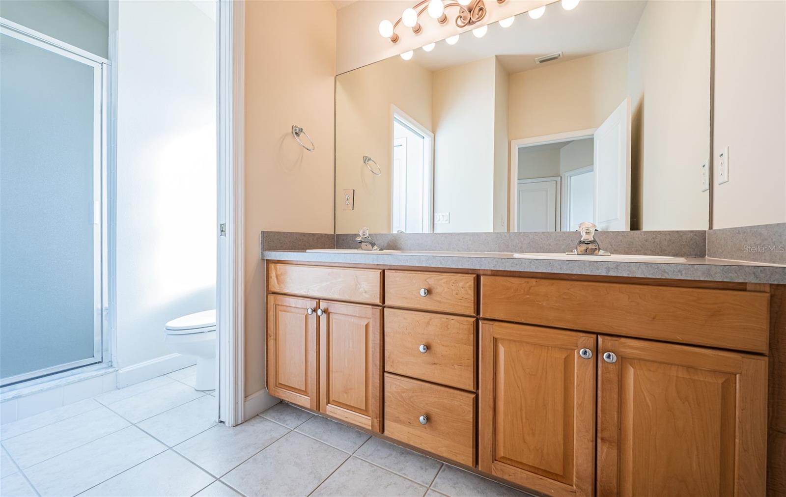 Full third bath with double sinks and large vanity.