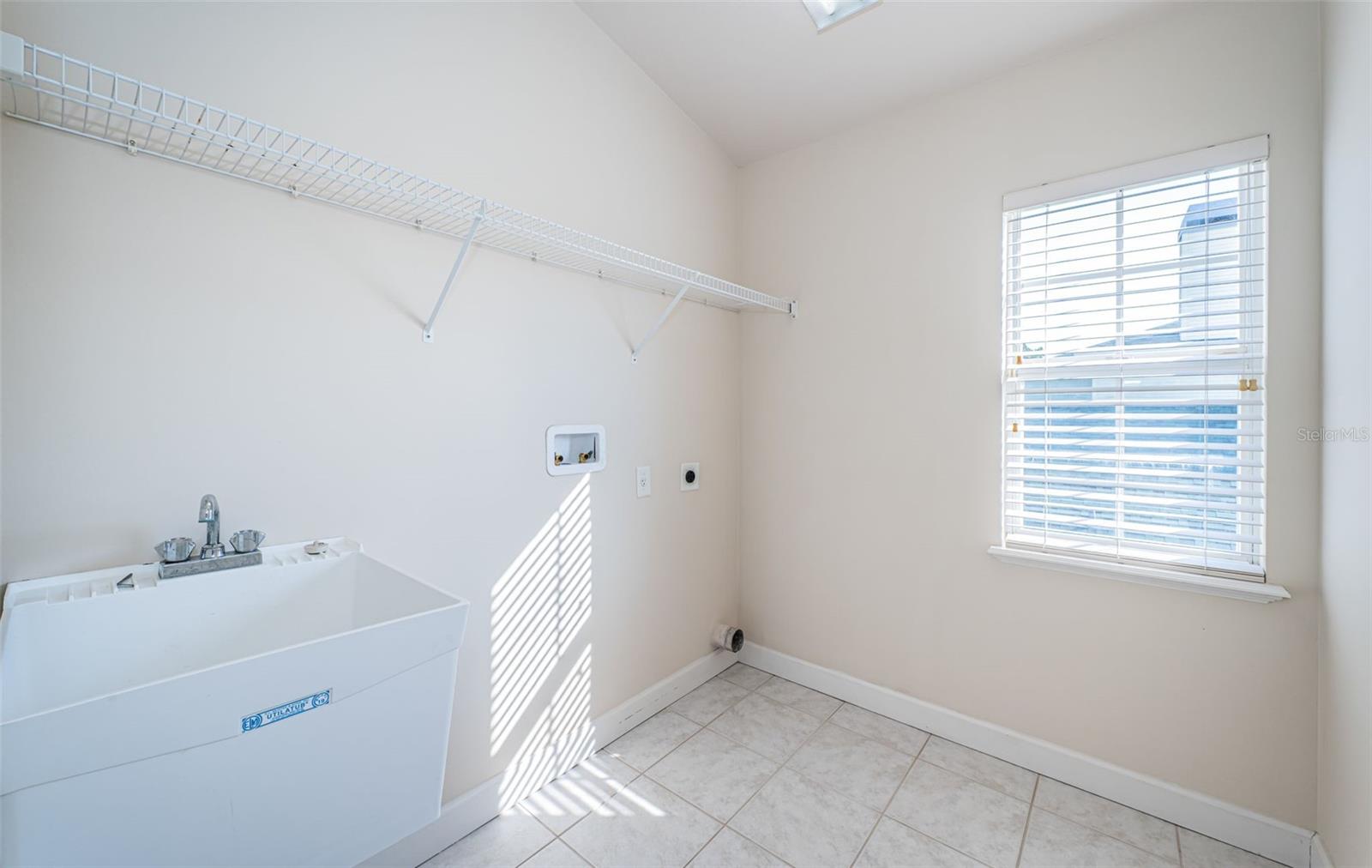 Upstairs laundry room with sink.