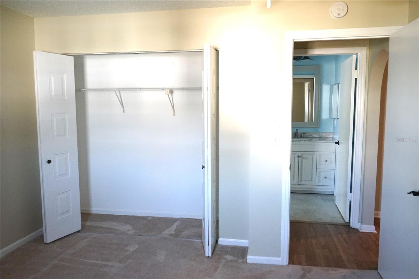 guest closet and short hall to bathroom