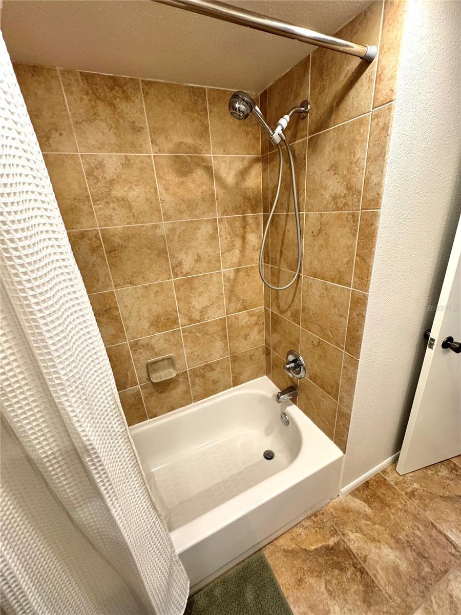 Updated tile in tub/shower area of guest bathroom.