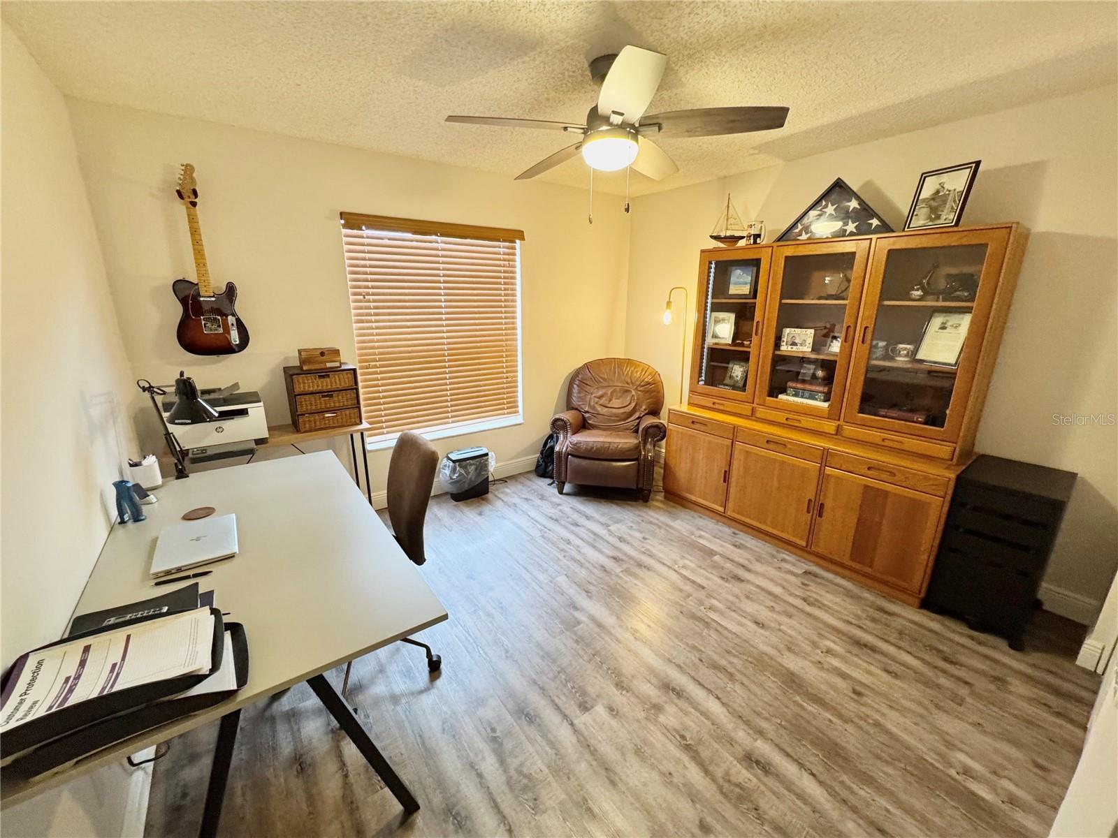 The spacious guest bedroom is currently being used as an office and music room.