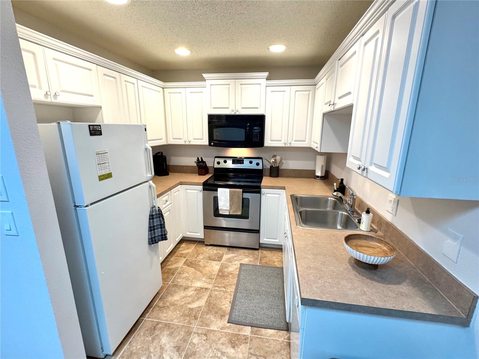 The updated kitchen has nice, recessed ceiling light.