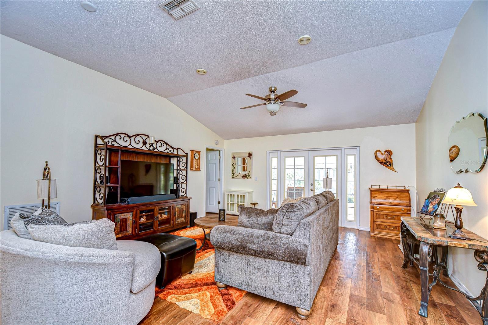 Living room features gorgeous double doors leading out to the patio!