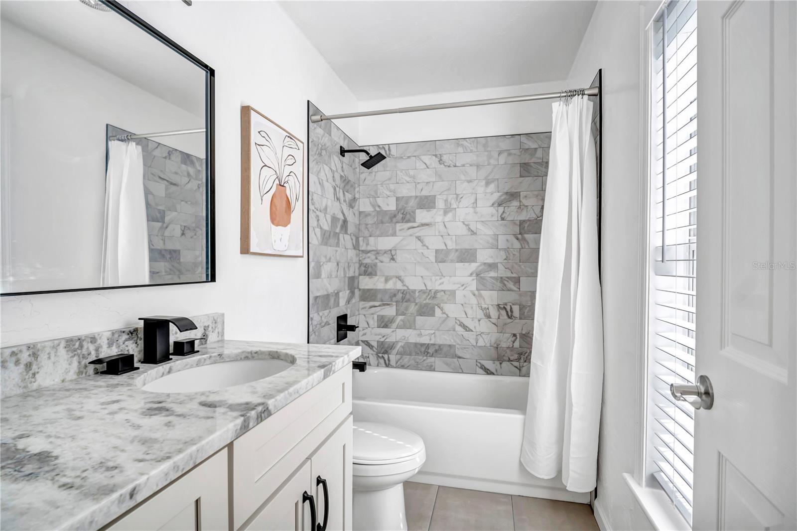 Primary bathroom with large standing shower and dual sink vanity