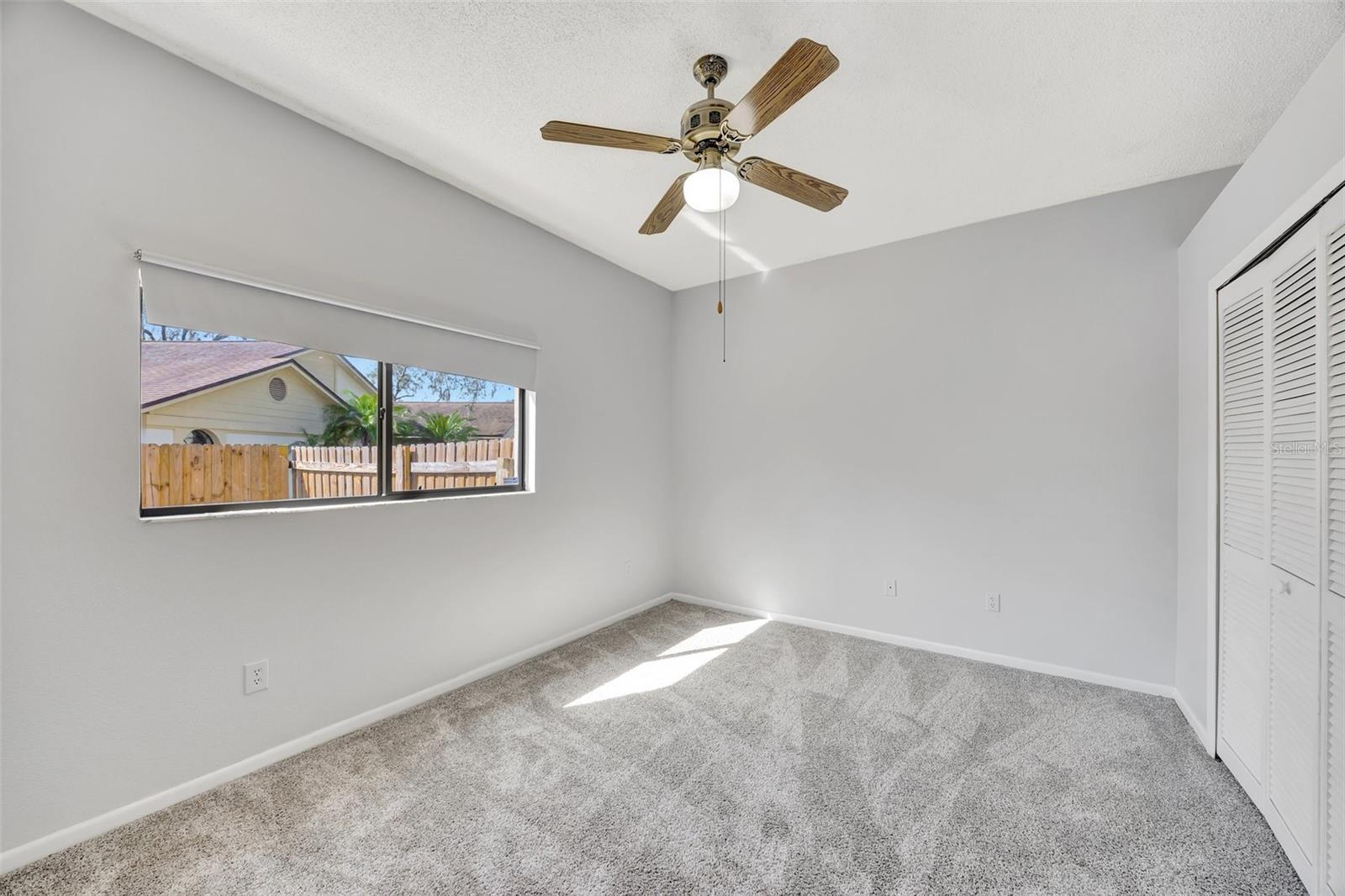 Spacious Bedroom with Ceiling Fan.