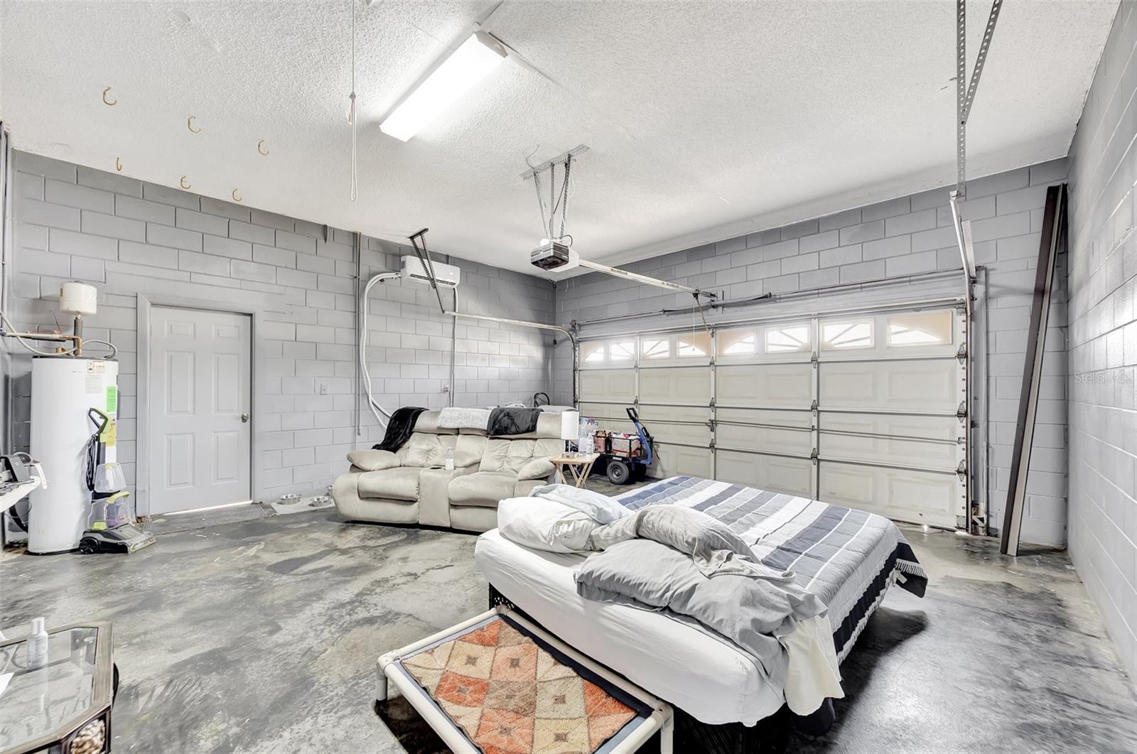 The garage has a mini-split ac unit and painted concrete floor which can also be used as a Man Cave or playroom.