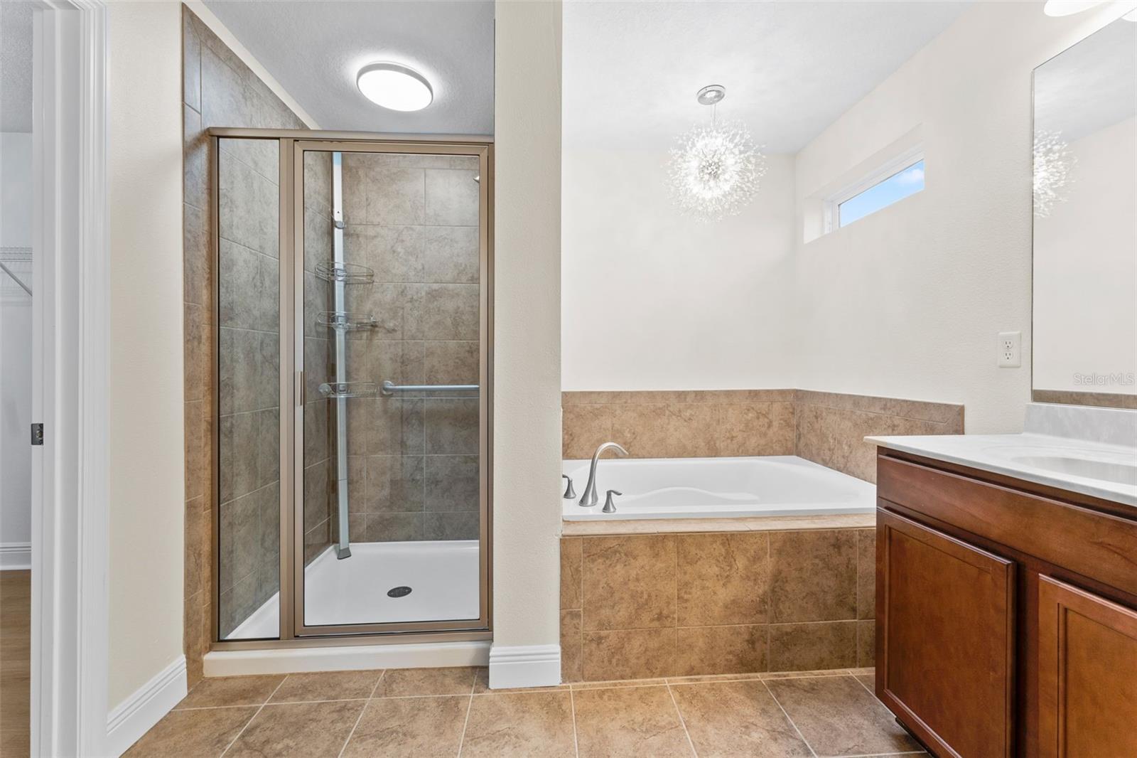 Large Master Bathroom Featuring Dual Sinks, Upgraded Faucets, Soaking Tub & Separate Shower Stall