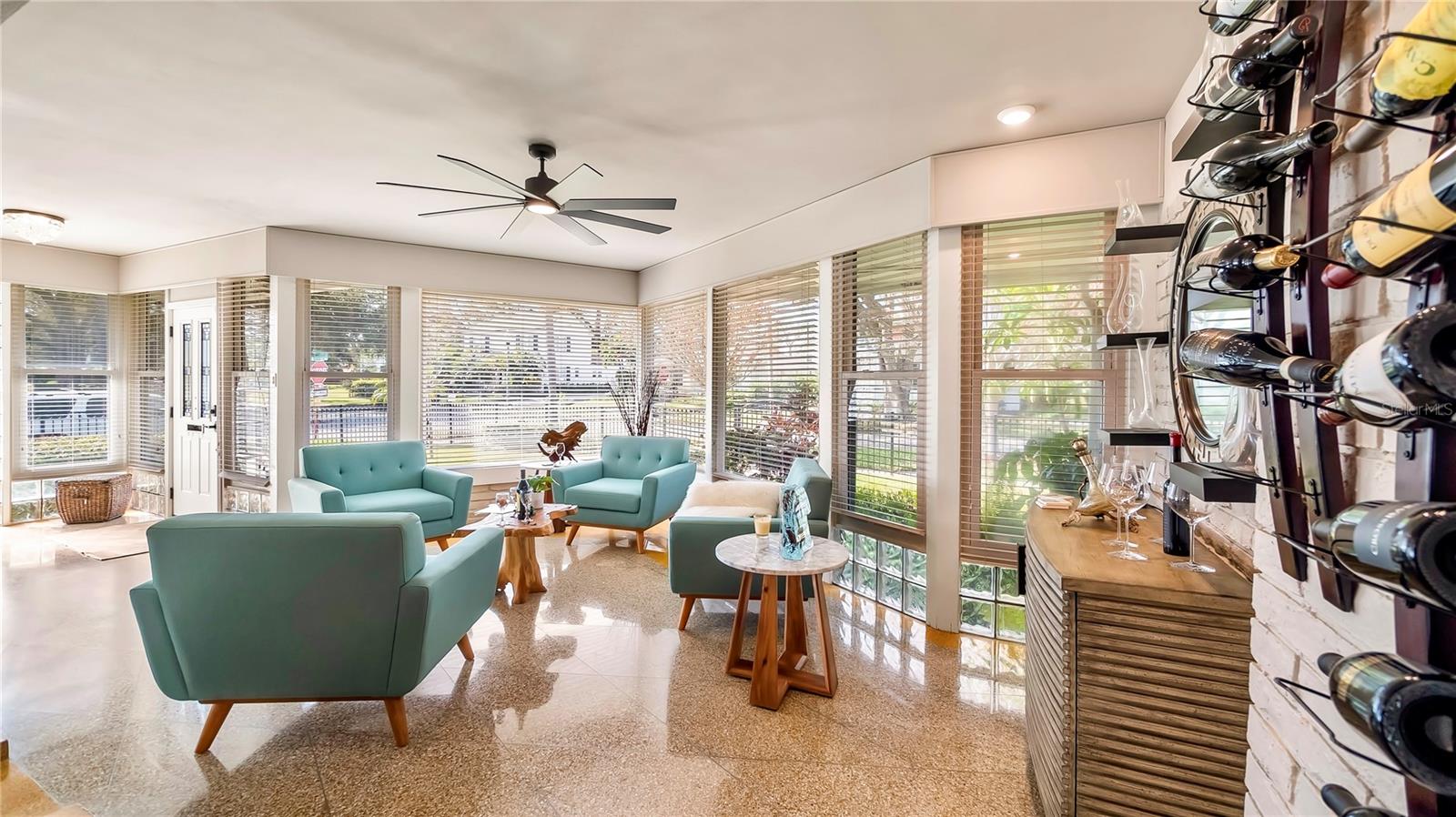 Versatile Den/Wine Room with plenty of natural light and comfortable seating.