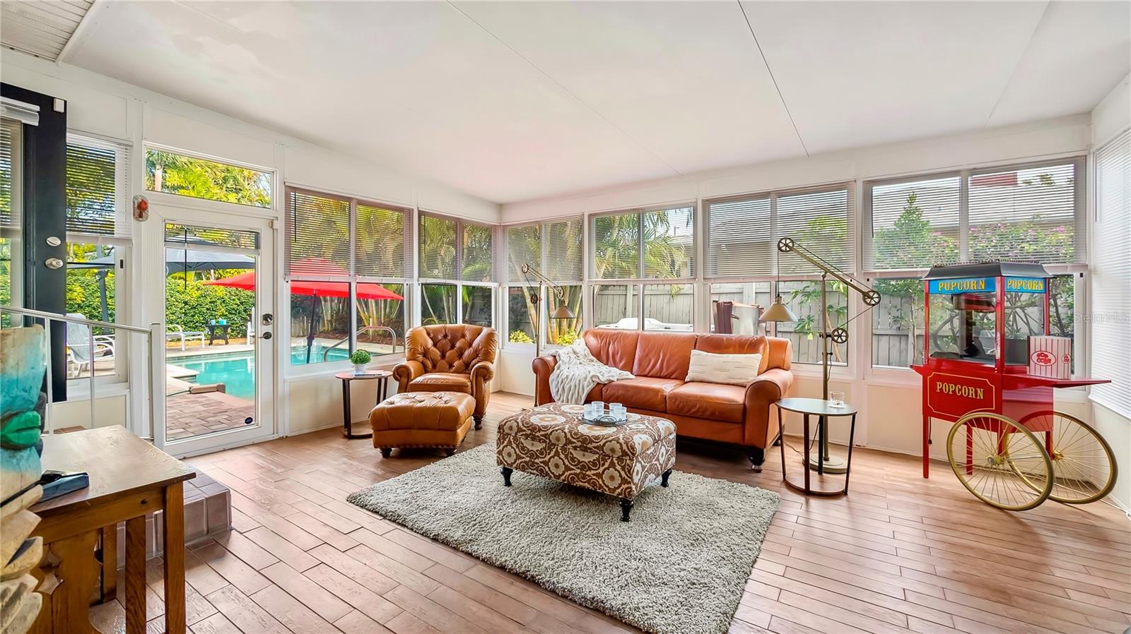 Relax and entertain in this inviting Florida room with a view of the sparkling pool