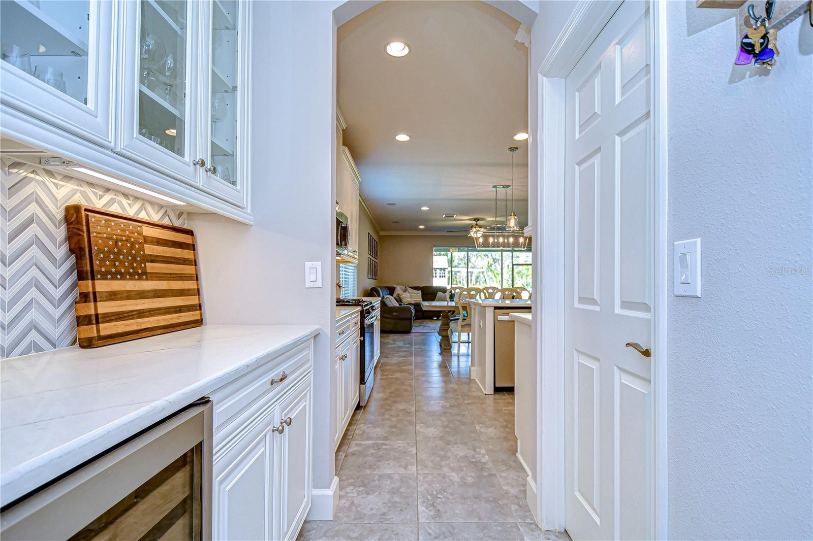 Stunning dry bar area with herringbone backsplash.