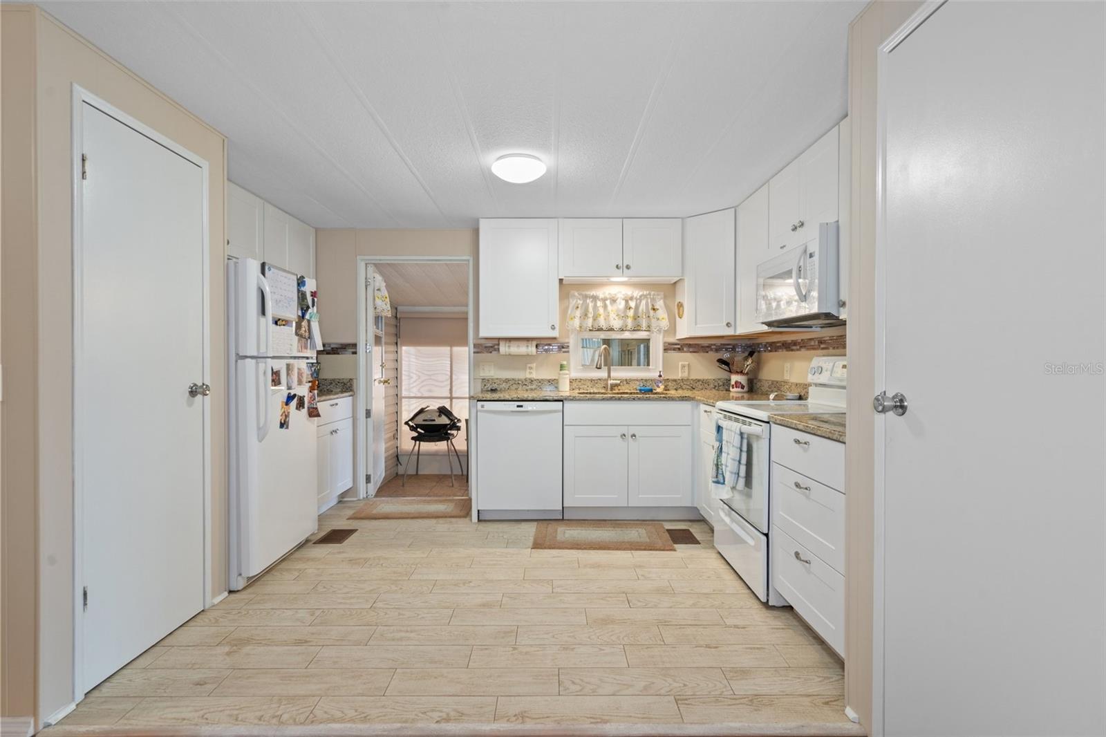 The Kitchen has gorgeous wood-look tile floors