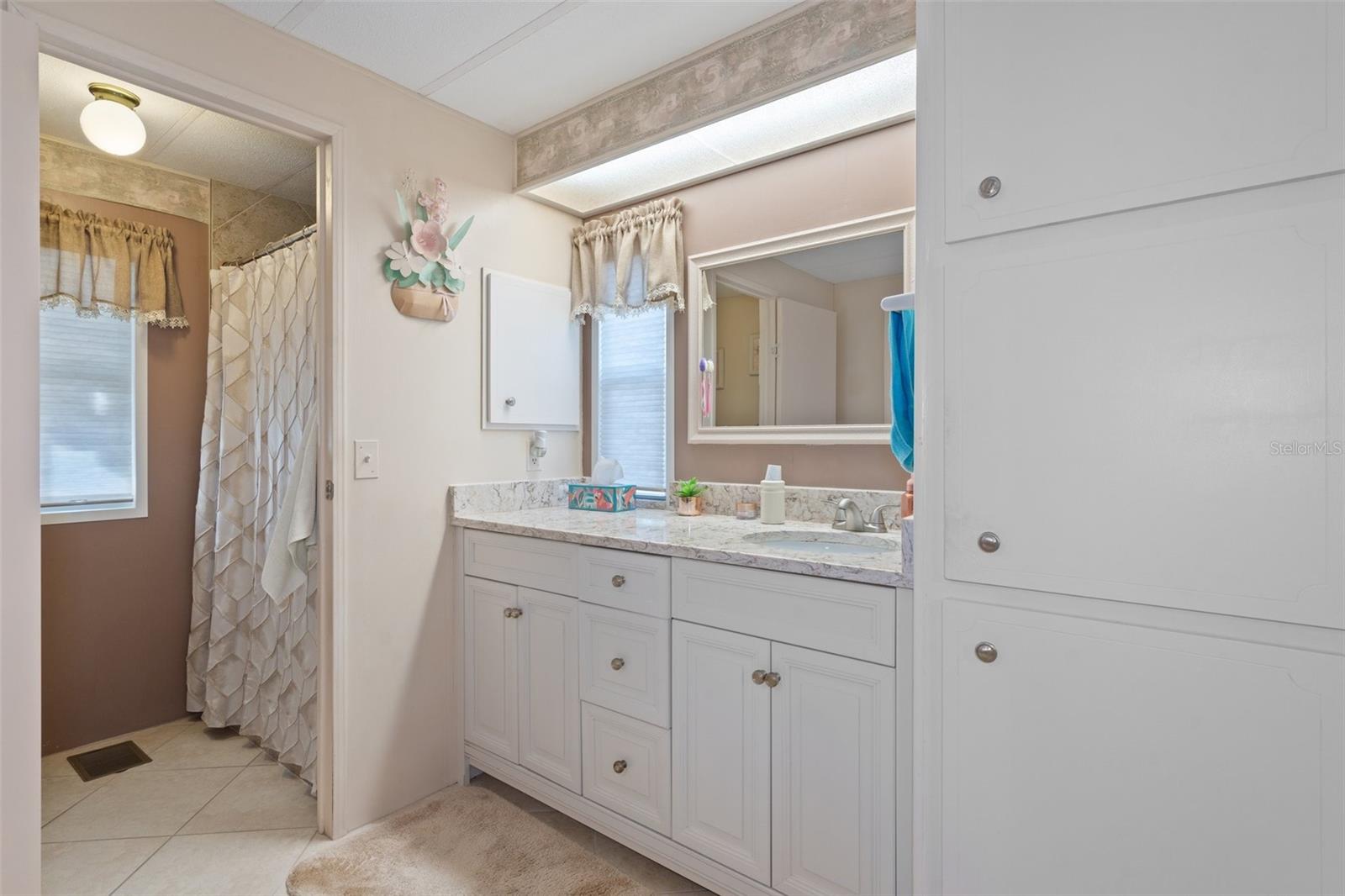 Notice the additional storage cabinets in the master bathroom