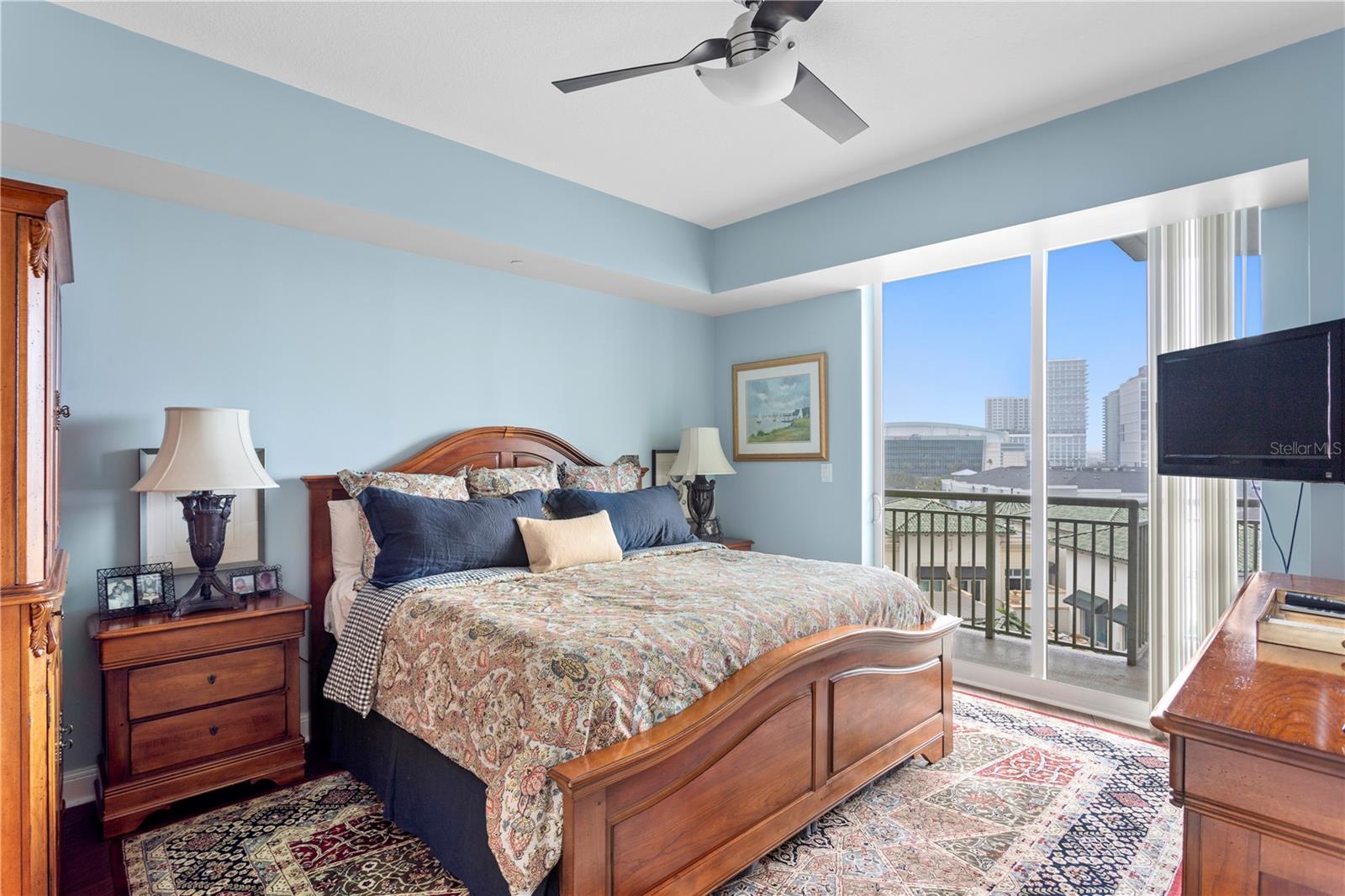 The primary bedroom is spacious with large sliding glass doors that lead to the wrap around balcony with views that extend to the gorgeous downtown skyline.