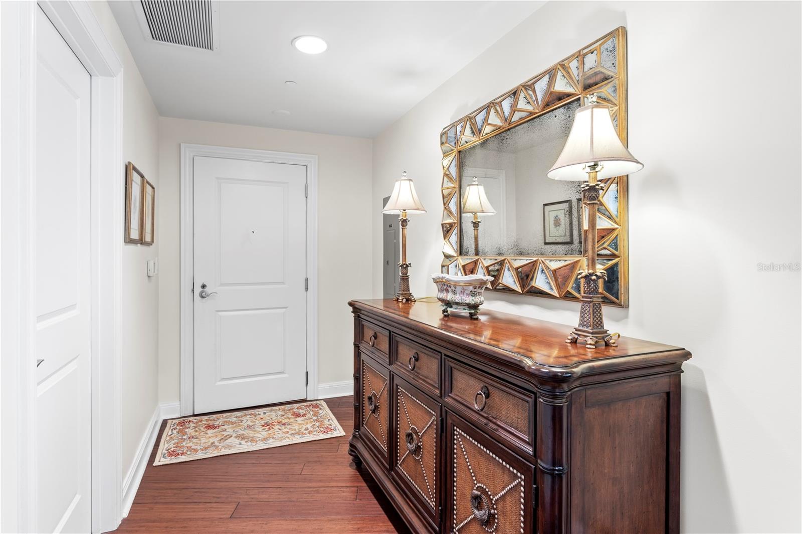 The open concept floorplan flows seamlessly from the entry hallway to the open kitchen and living and dining spaces.