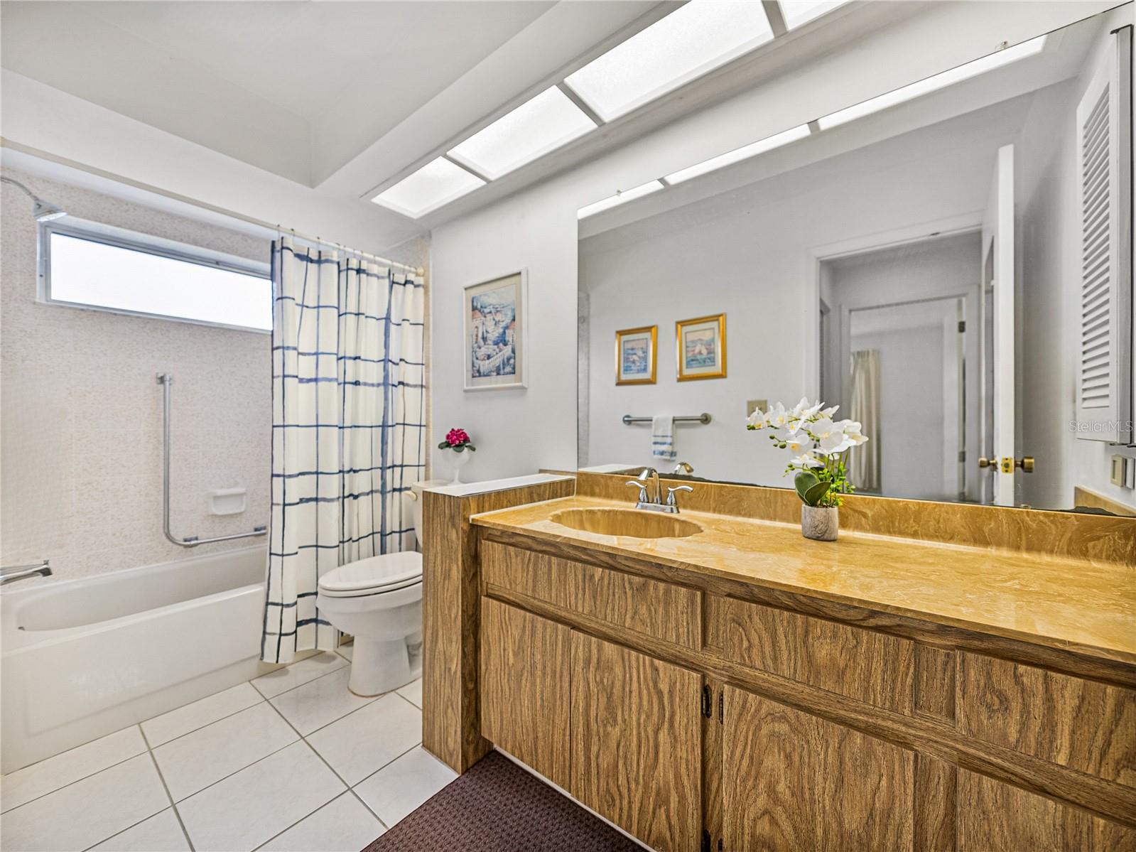 Hall bath conveniently located between guest suite and main living~