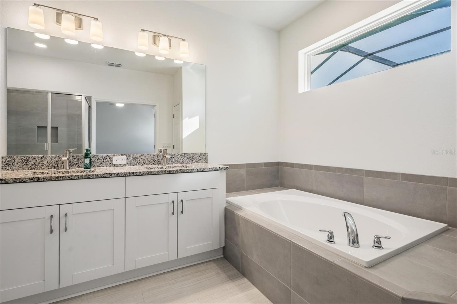 Large soaking tub and dual sinks in owners bath