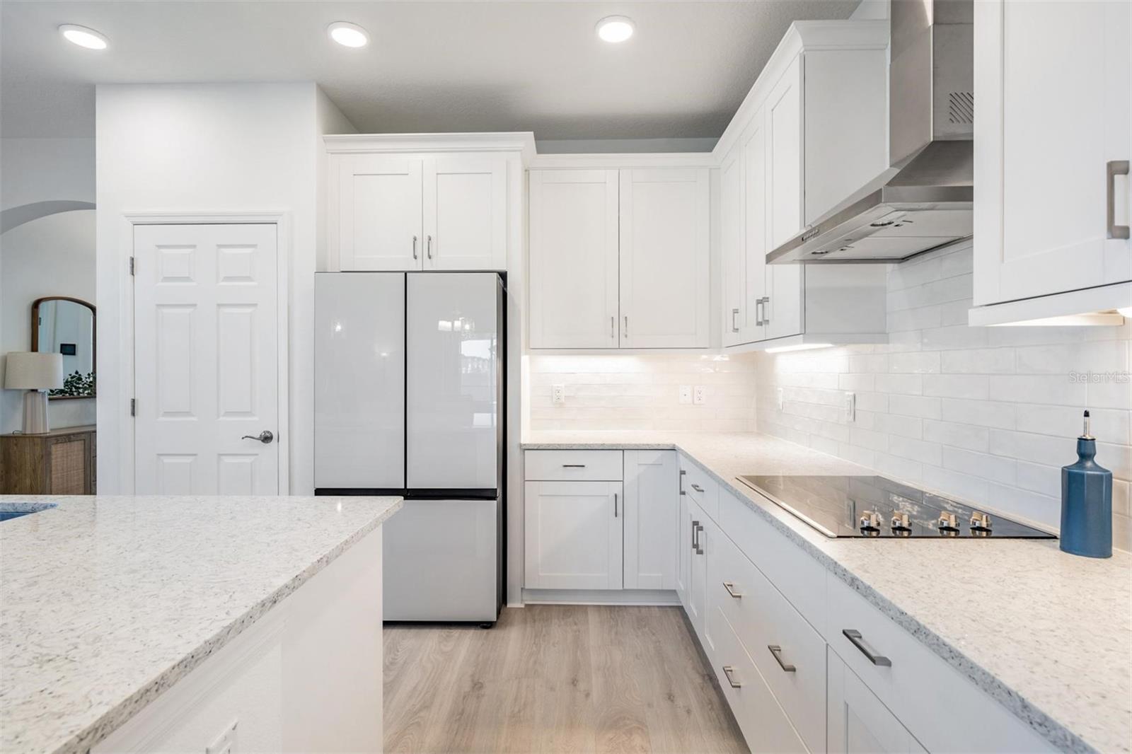 Gorgeous with the light and bright quartz and backsplash!