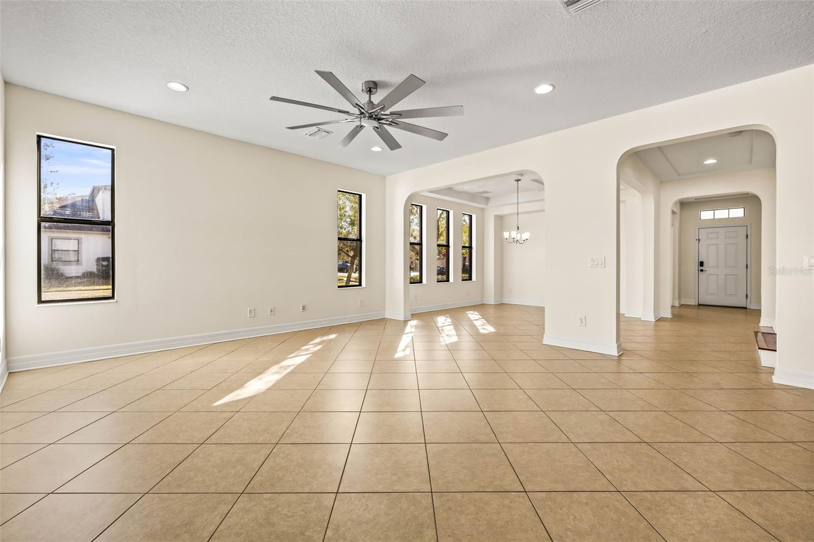 Overhead fan and large windows create a welcome, bright space.