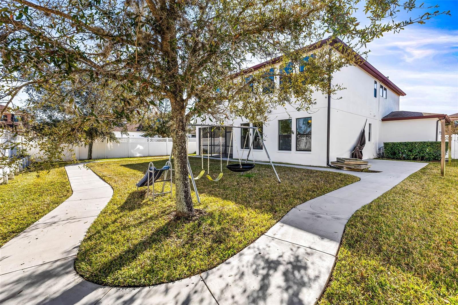 This huge backyard has a walking path and privacy fencing along your corner lot.