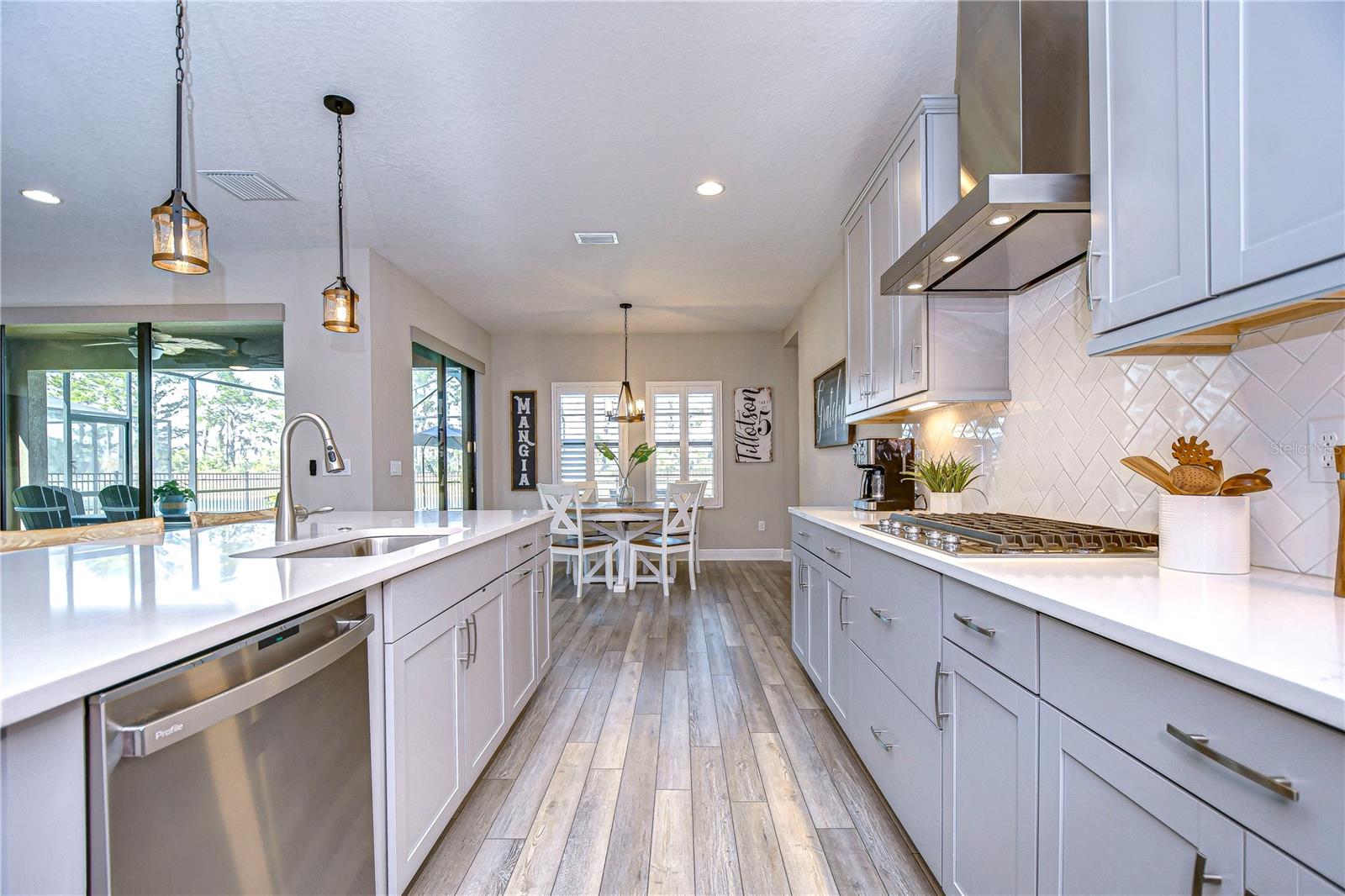 Range and accent lighting above the breakfast bar elevate the kitchen!