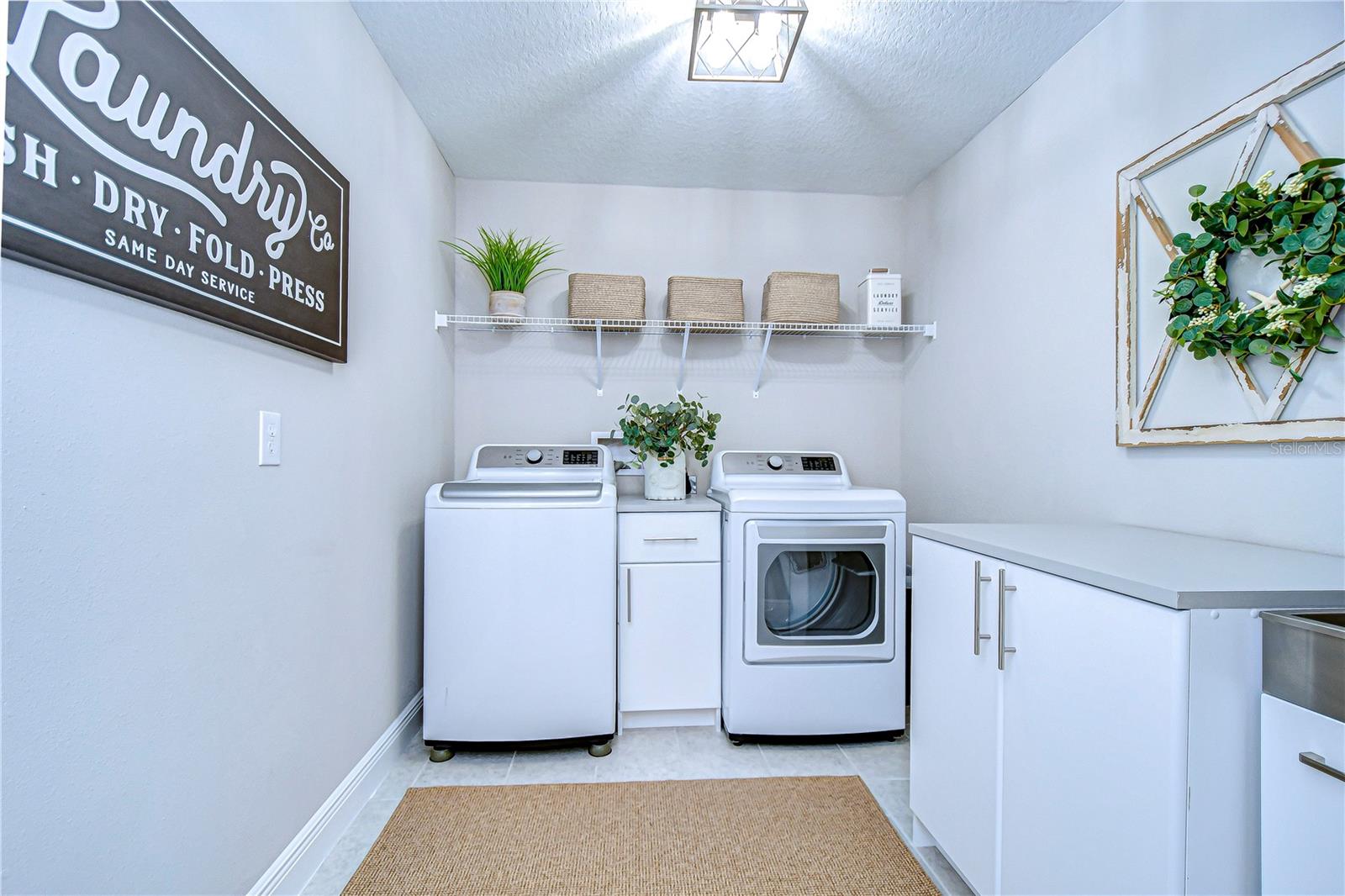 Large laundry room with folding and storage space.