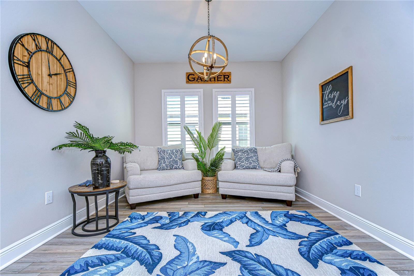 Formal living room is spacious and cozy, highlighted by wonderful plantation shutters.