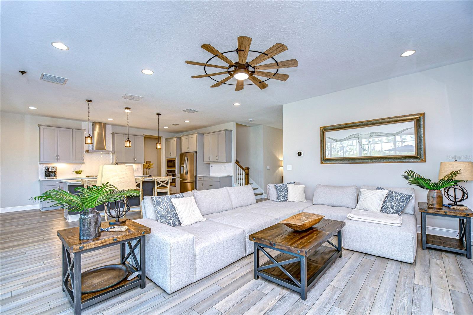 Living room is expansive! Recessed lighting and artisan ceiling fan accent the space.