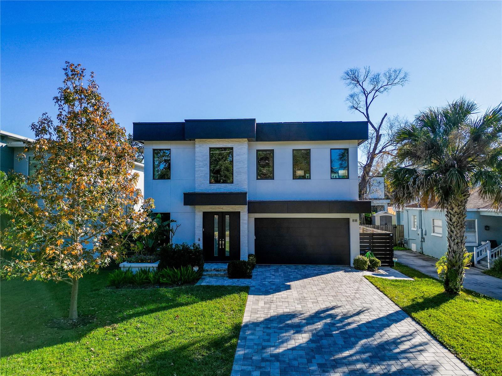 Pavered driveway and mature landscaping