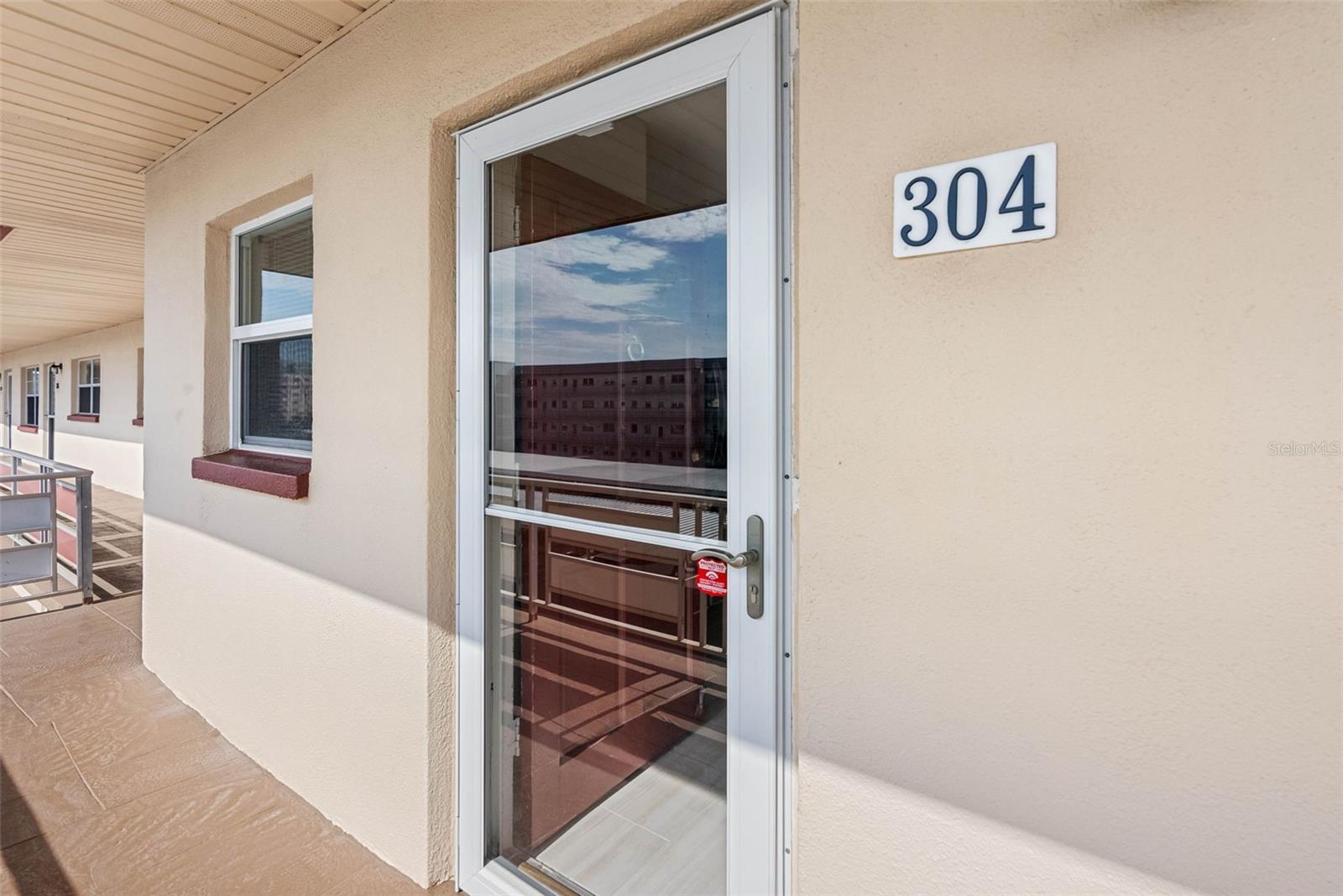 Storm door to the top floor condo.