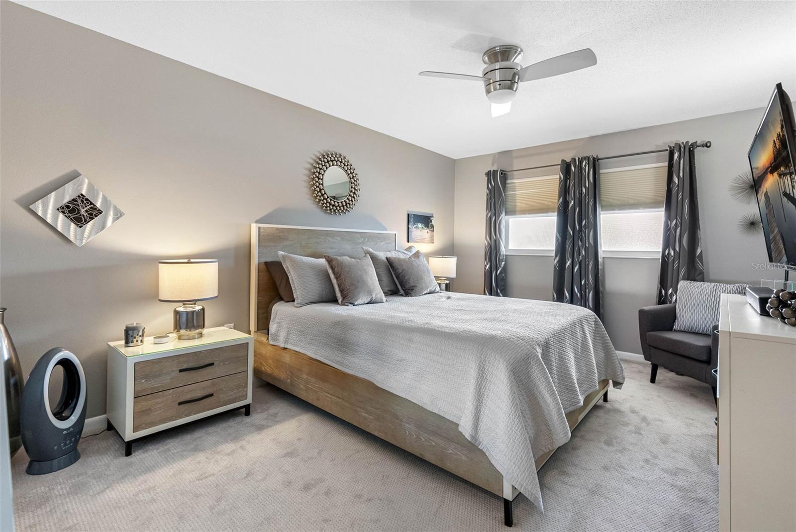 Spacious bedroom with a walk-in closet and plush finishes.