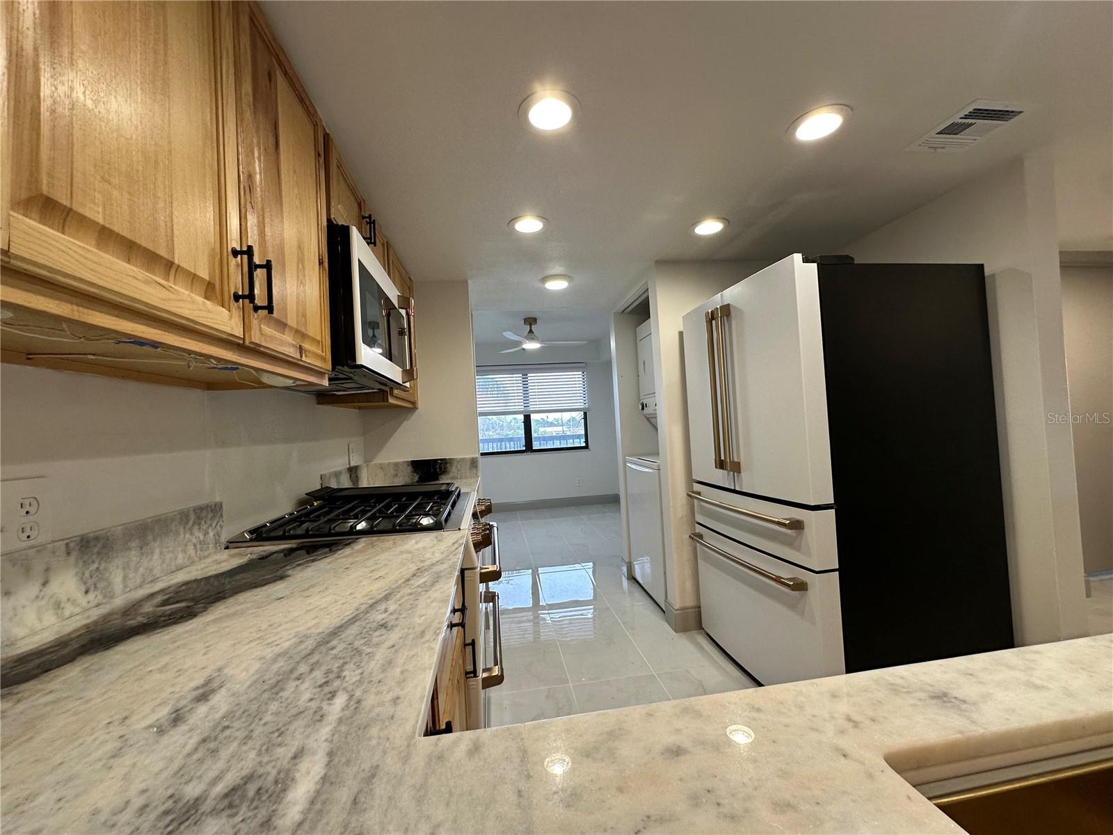 Kitchen with beautiful granite countertops and brand new GE Cafe Appliances