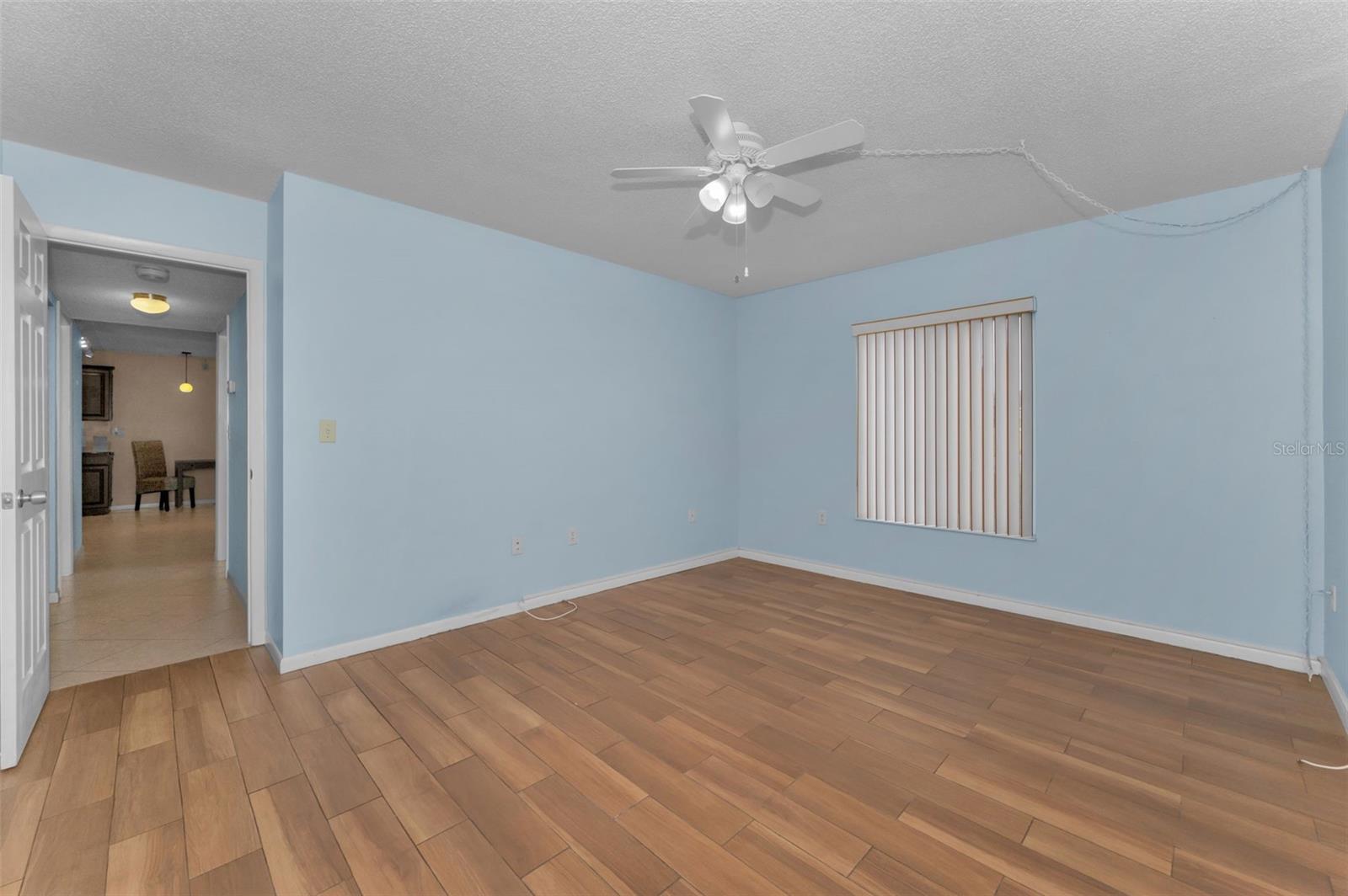 View of primary bedroom toward hallway