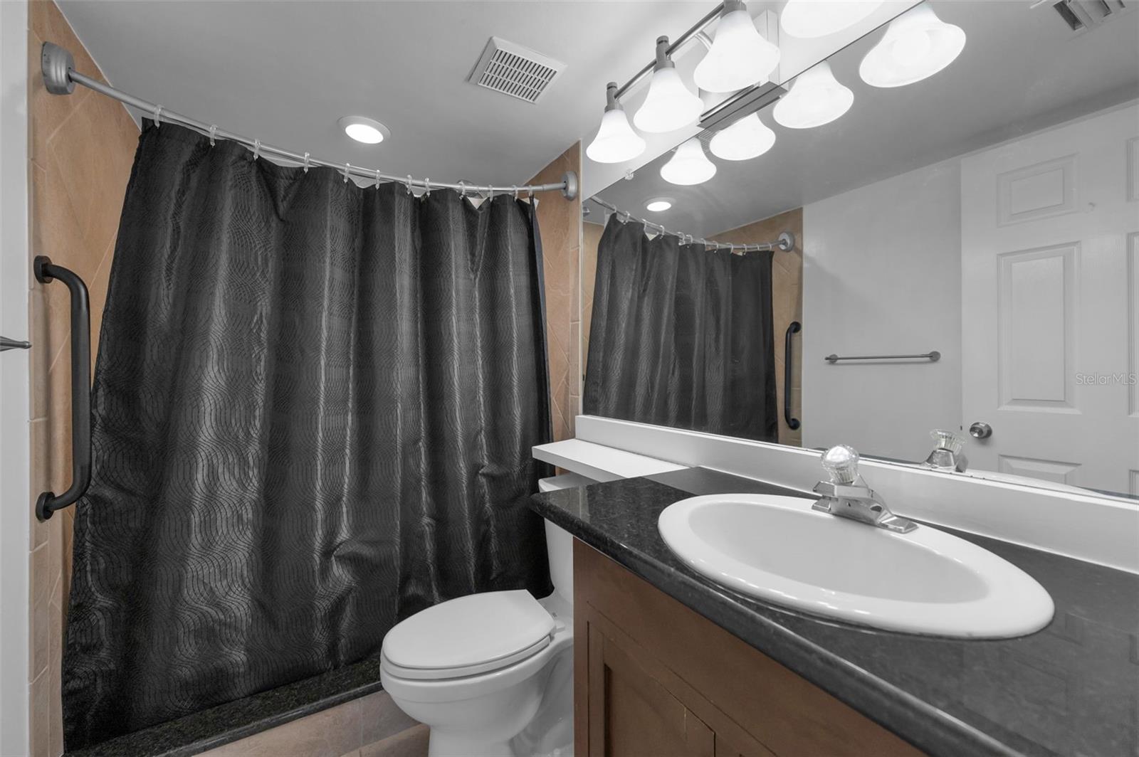 En-suite bathroom with granite counters