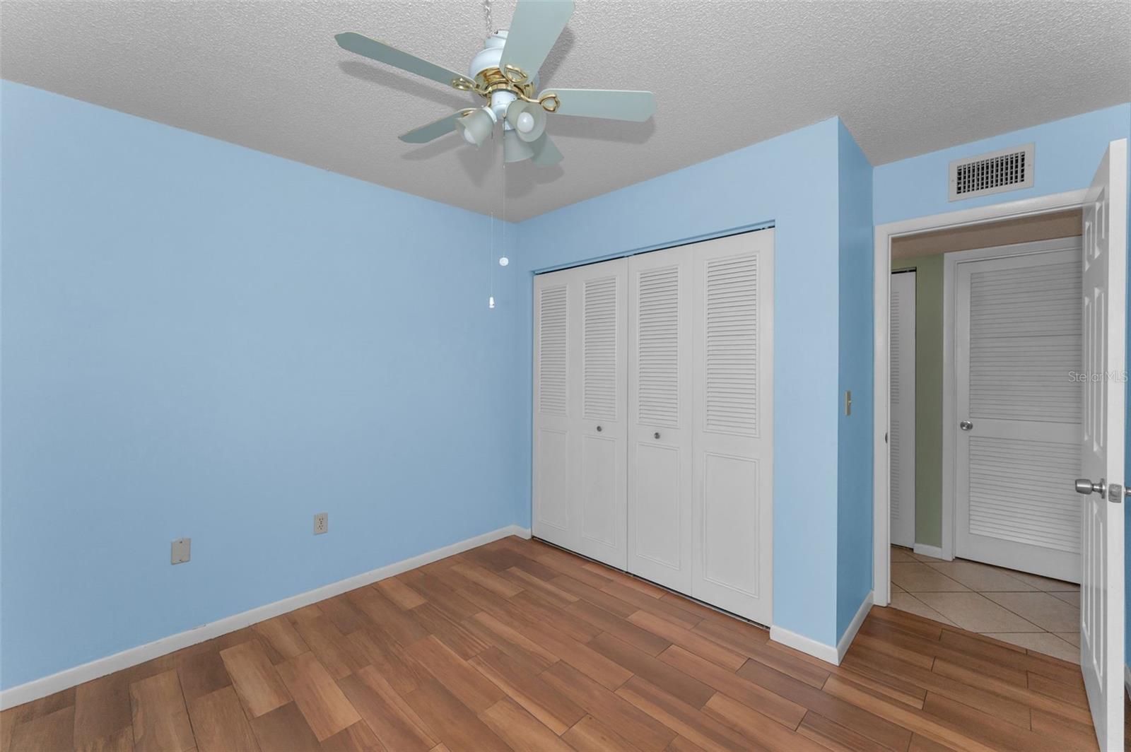 View of guest bedroom toward doorway & double closet