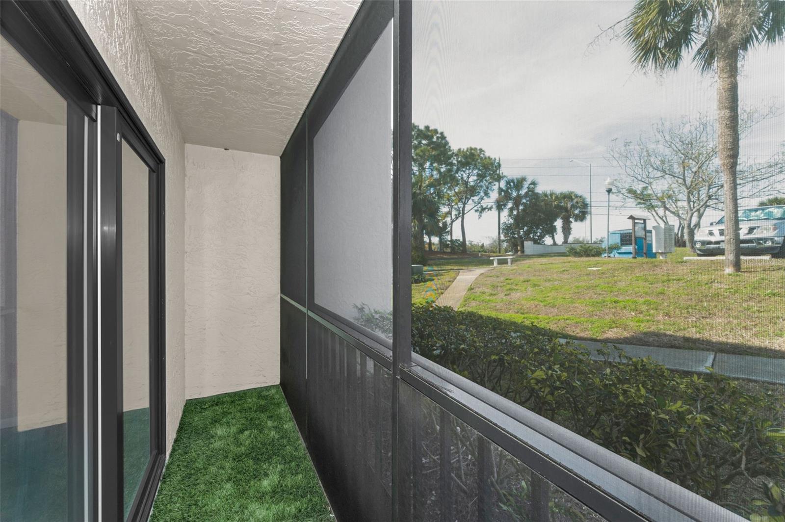 Covered & screened Patio with sliding doors to living room