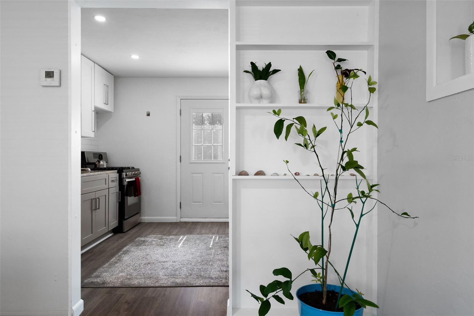 View from living room into kitchen with backyard access just beyond.