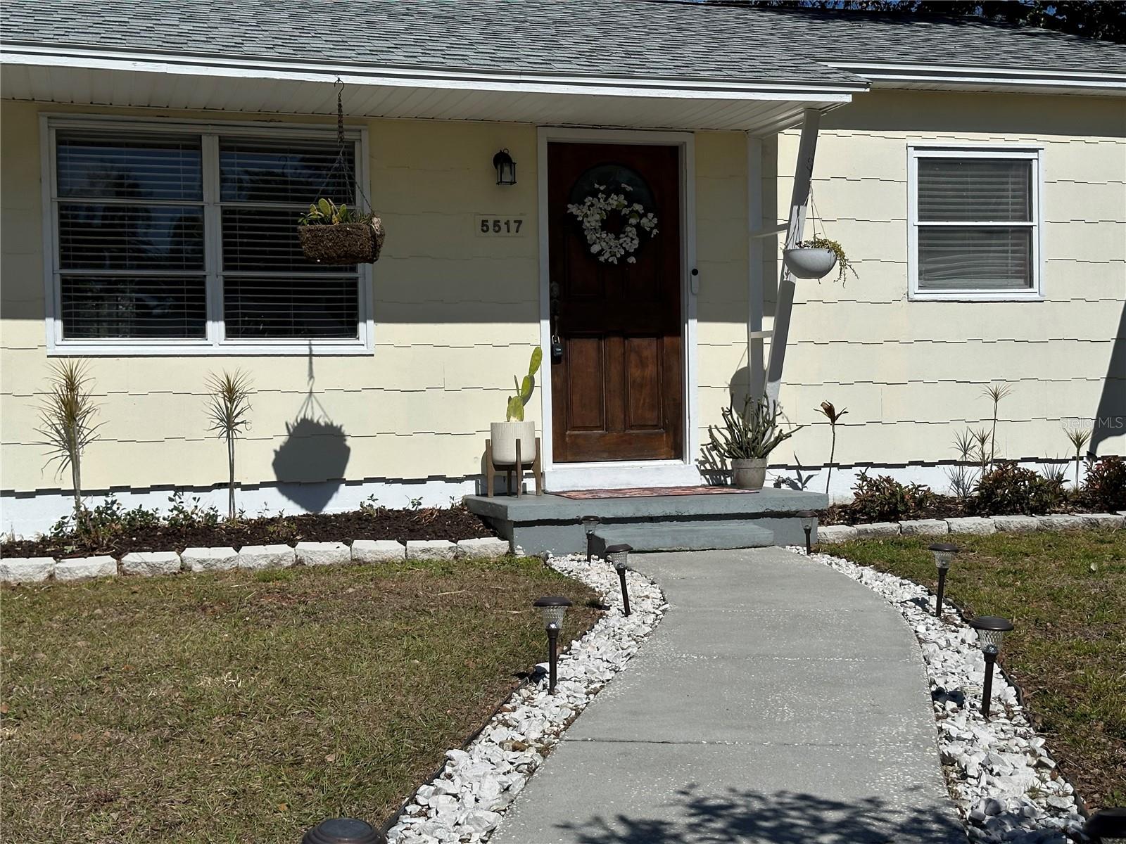 Lighted gravel lined front walkway