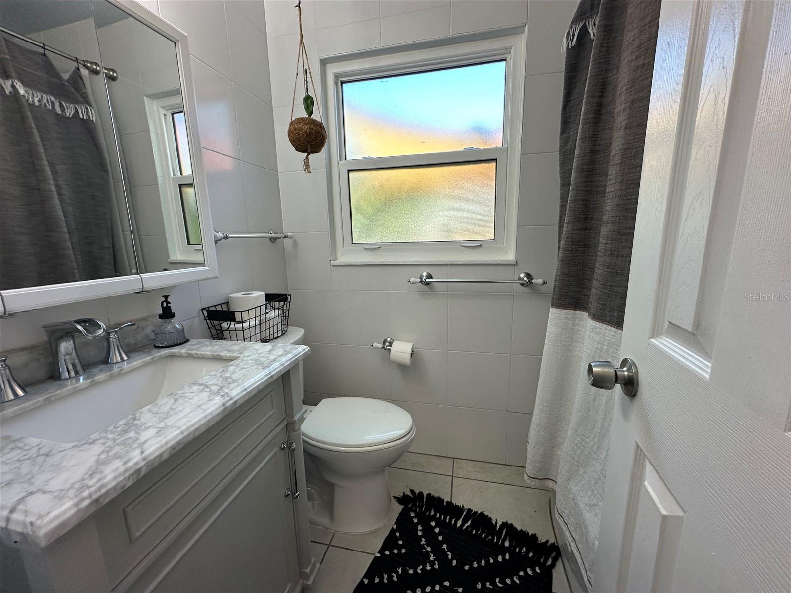 Nicely appointed bathroom. Frosted window provides natural light.