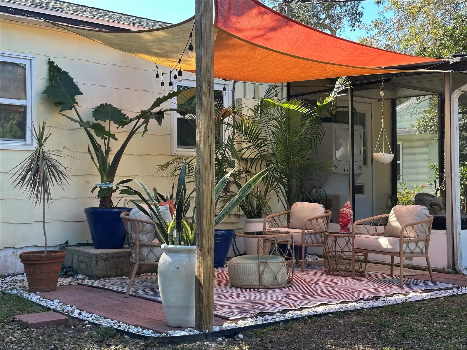 Lovely outdoor patio covered by sail shade