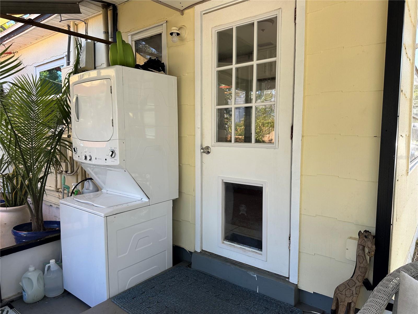 Stacked laundry in screened porch conveniently accessed from the kitchen