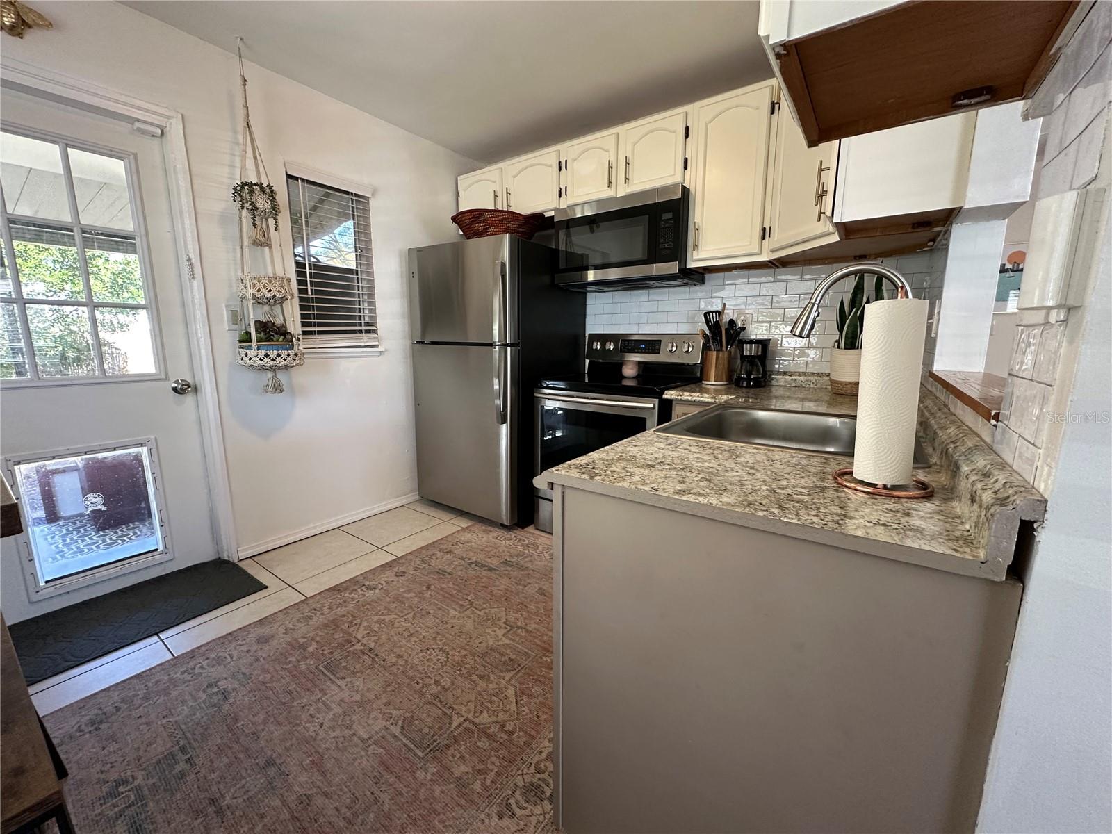 Kitchen layout with door to screened porch and laundry