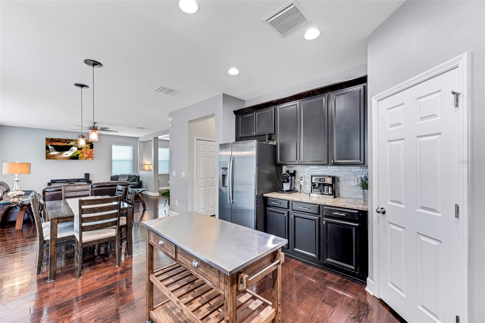 The spacious corner walk-in pantry offers abundant storage for all your culinary essentials, while the countertops on both sides of the kitchen provide the perfect space for a coffee station or additional prep area.