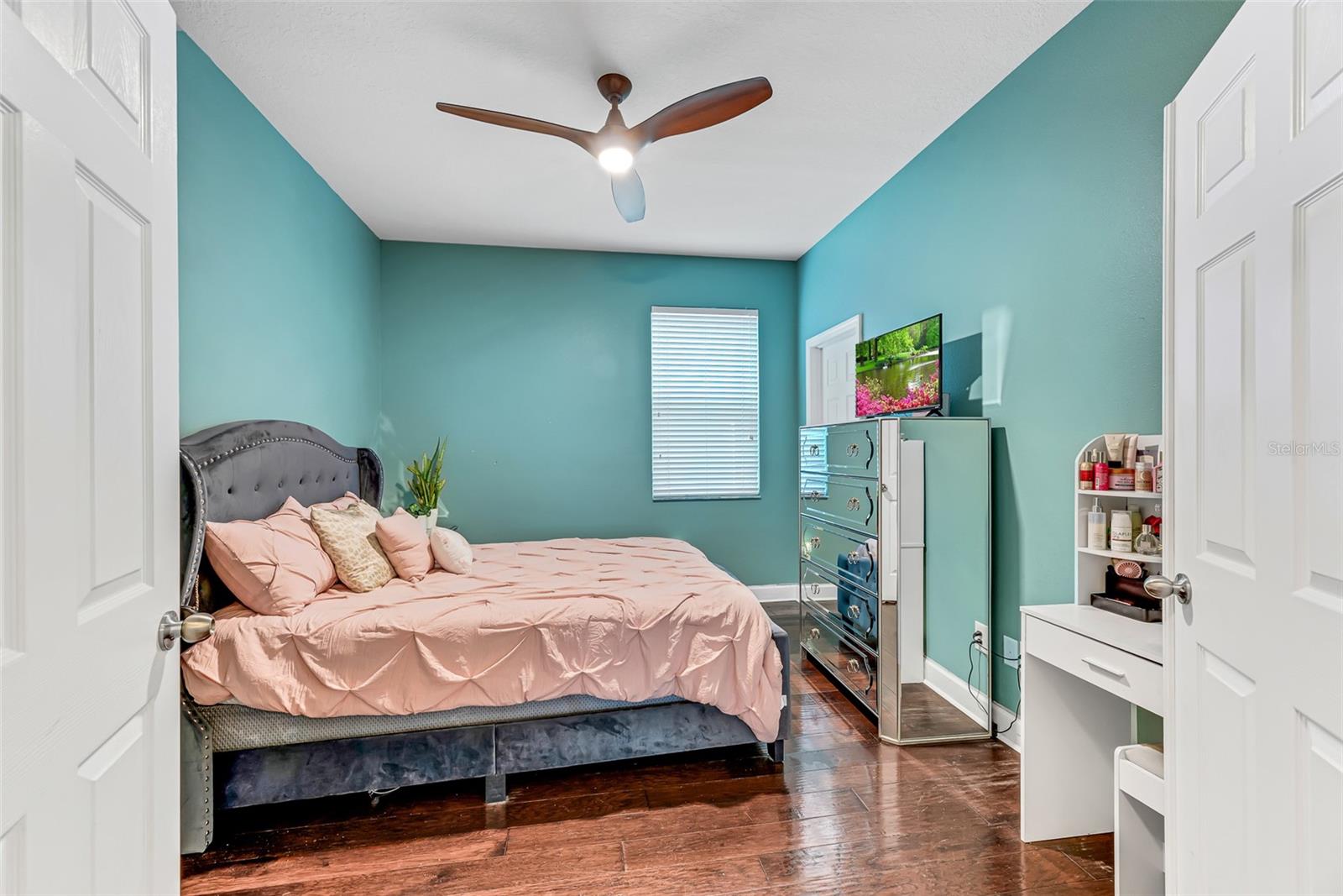 Bedroom #5, located on the first floor, features its own walk-in closet and easy access to a full bathroom, offering extra privacy and versatility.